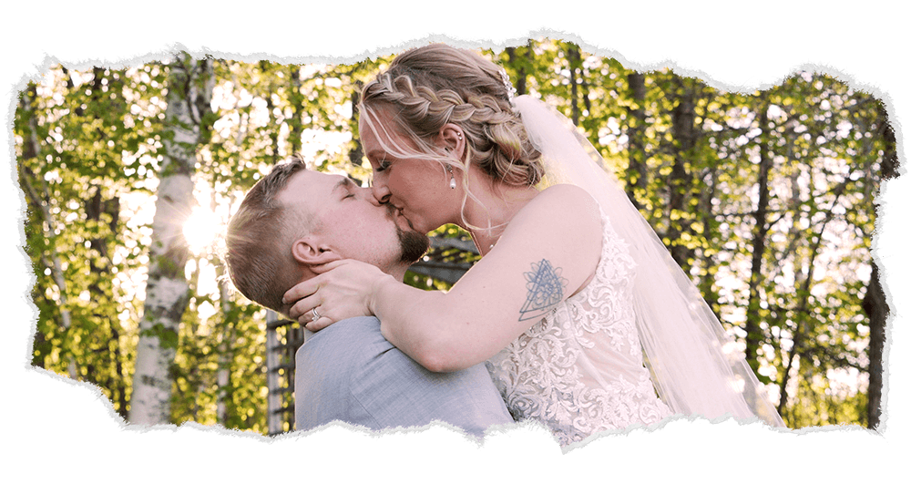 Bride and groom sharing a sunset kiss in a forest near Duluth.